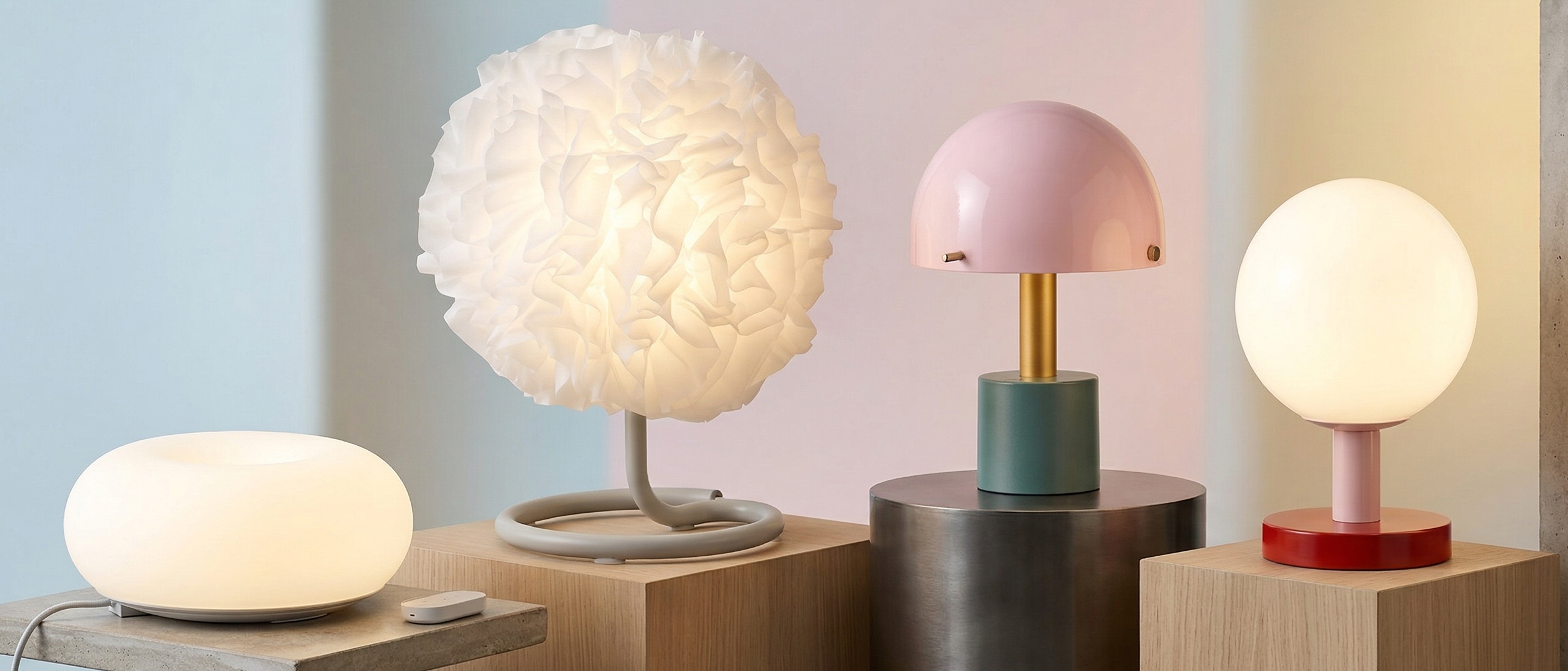 Selection of IKEA lamps on plinths, with a colorful background