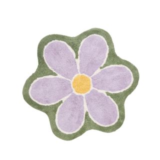 A purple flower rug with a green border