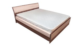Image shows a white mattress paired with a brown box spring and headboard