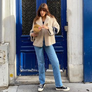 Diane wears her Converse with straight-leg jeans and a shearling coat.