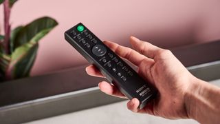 Sony HT-SF150 remote in someone's hand