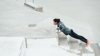 a photo of a woman doing an elevated push up