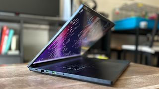 Razer Blade 18 gaming laptop half open on a wooden table