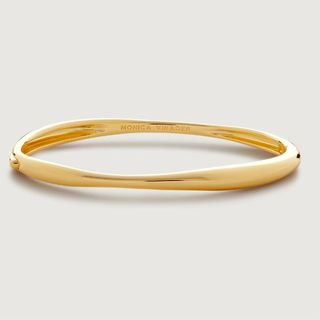 flat lay of gold bangle 