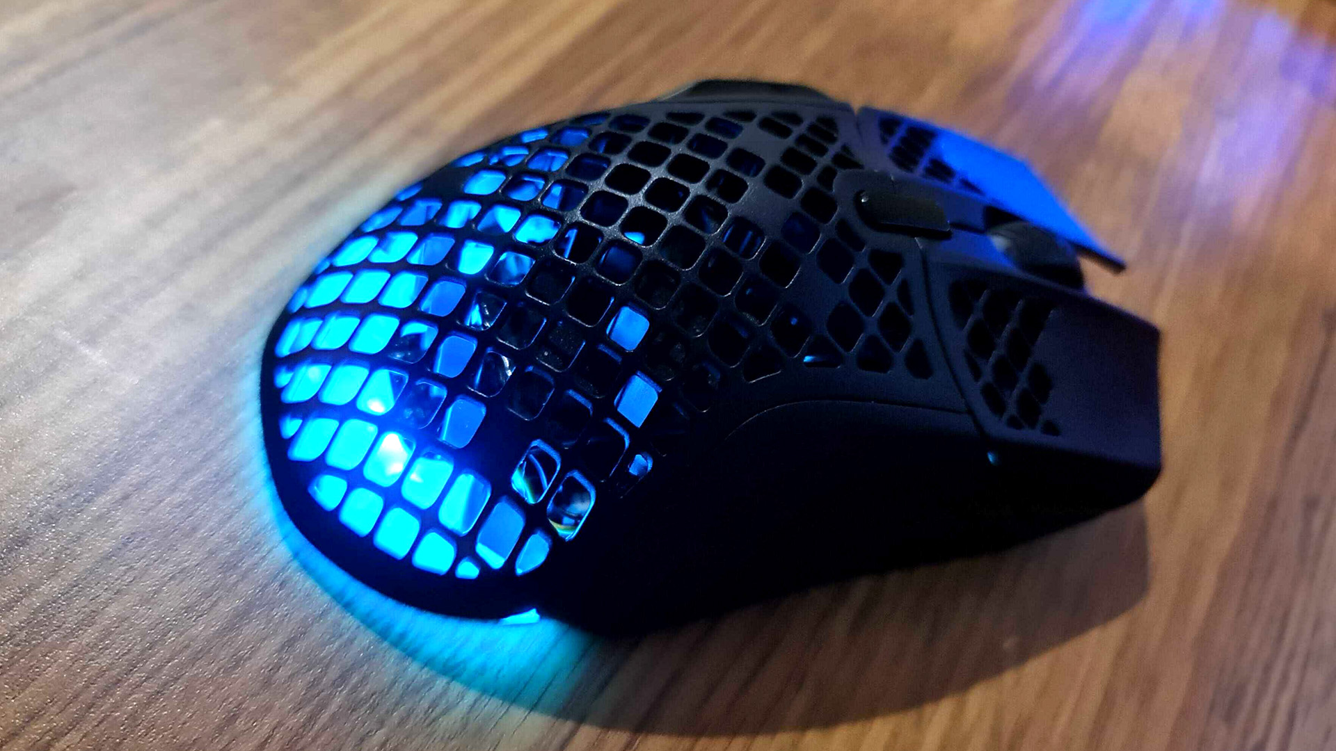 HyperX Aerox 5 gaming mouse with RGB lighting enabled.