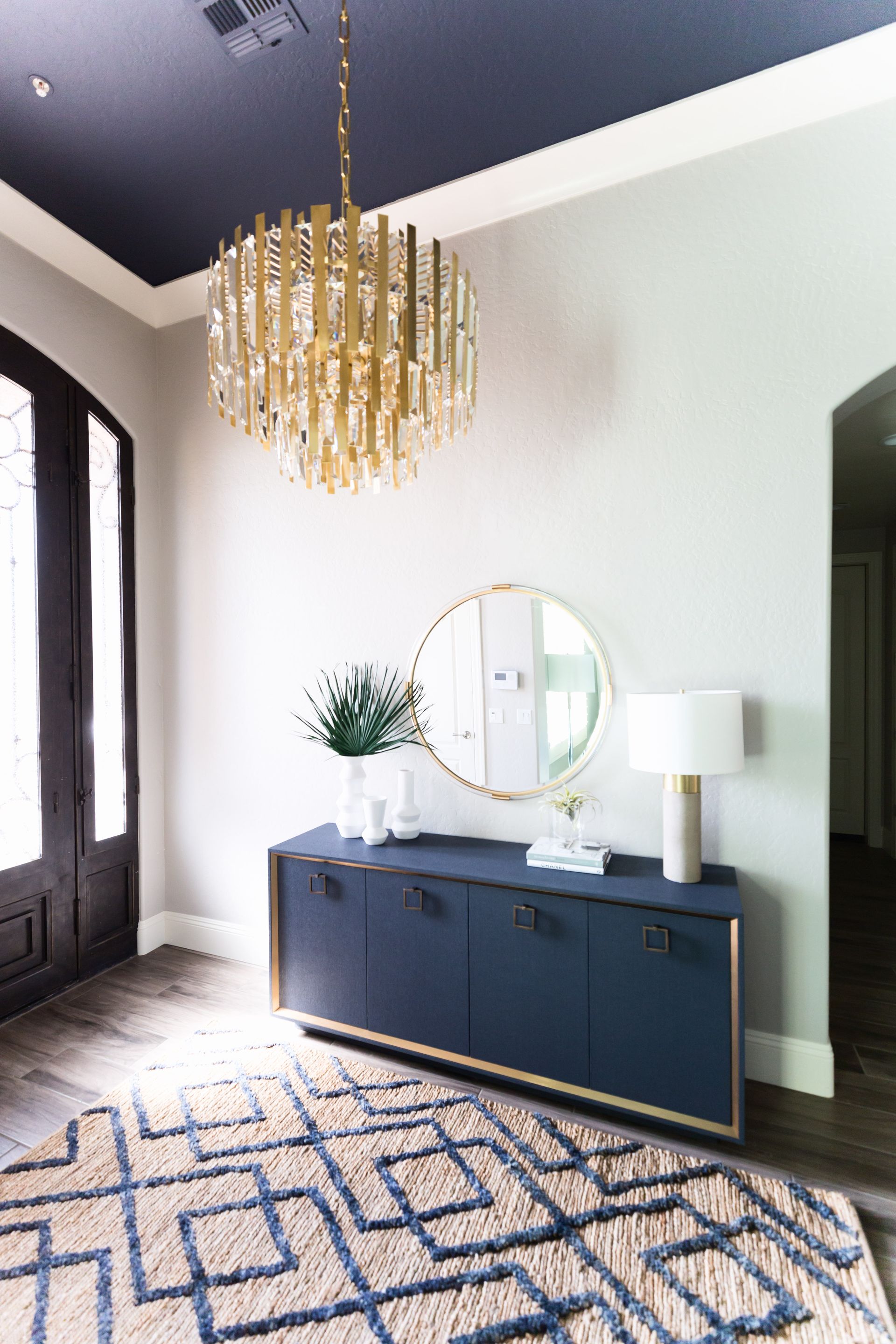 An entryway with blue ceiling and a blue storage unit