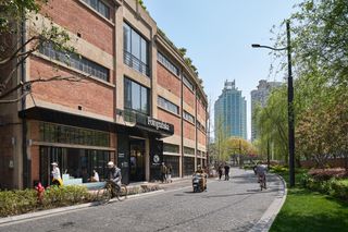 Fotografiska Shanghai by AIM Architecture showing the building's blend of old and new with raw concrete and plush interiors