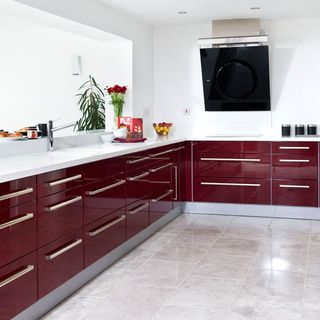 kitchen area with red cabinets and white wall