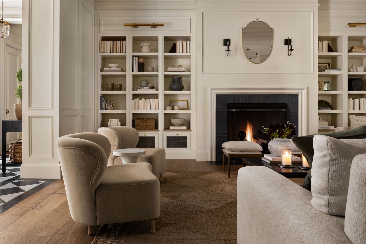 a neutral living room with bookshelves filled with objects and books