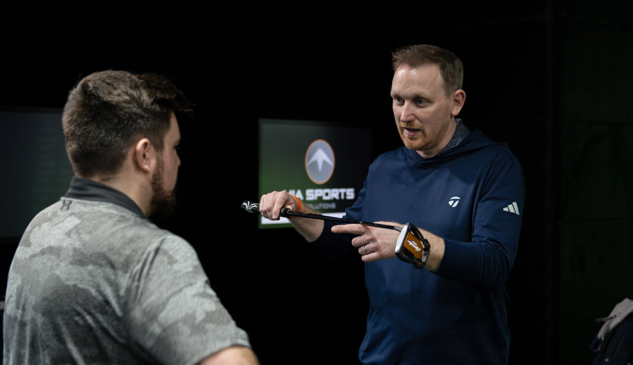A fitter shows off a putter