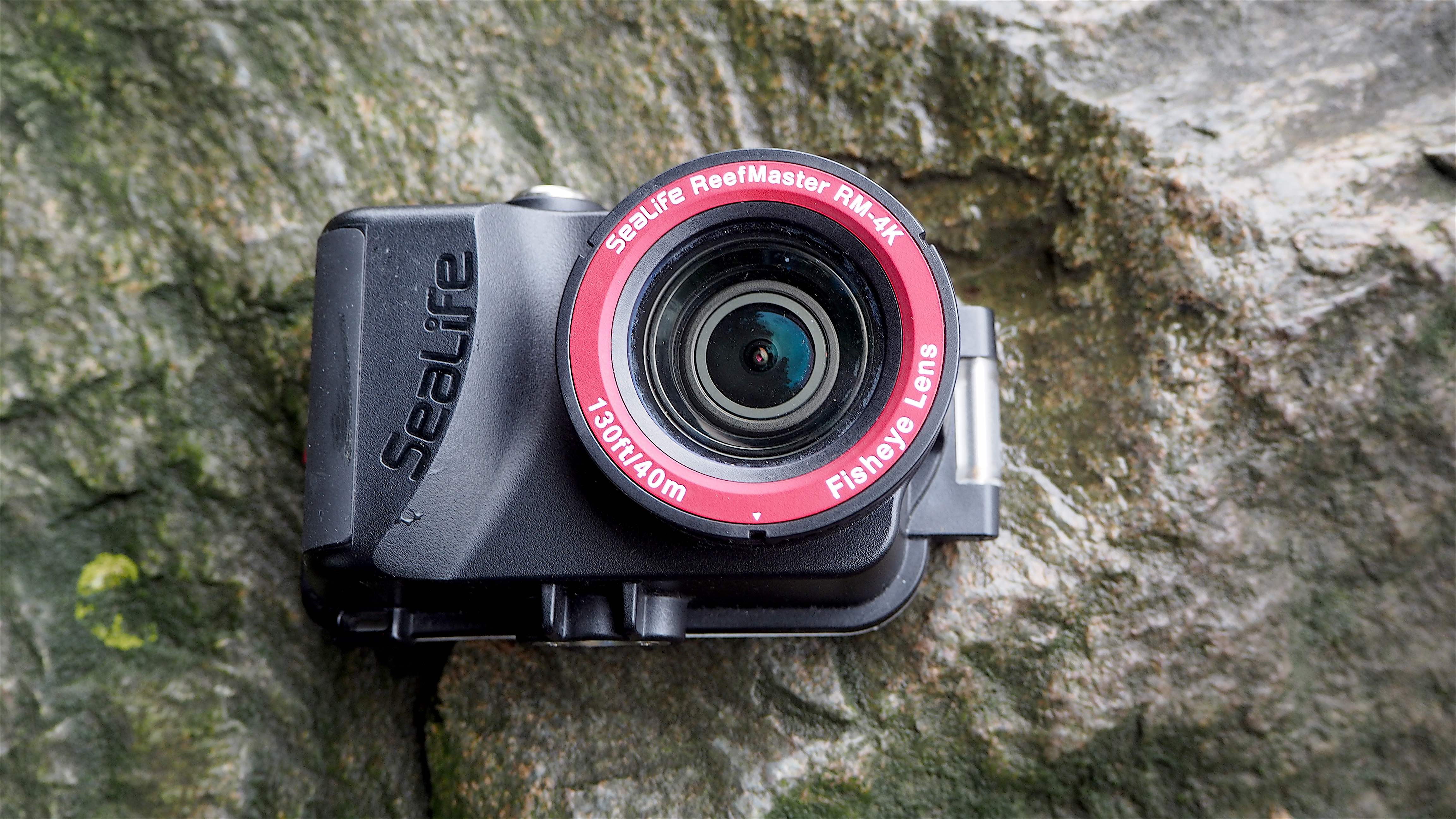SeaLife ReefMaster RM-4K waterproof camera on a stony waterside