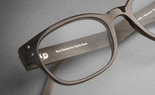 Oval eye glasses with a brown frame.