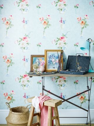 blue floral wallpaper in living room with desk and picture