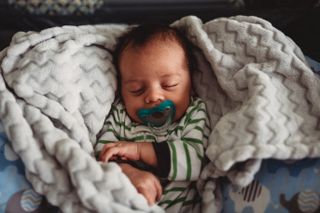 sleeping baby with dummy