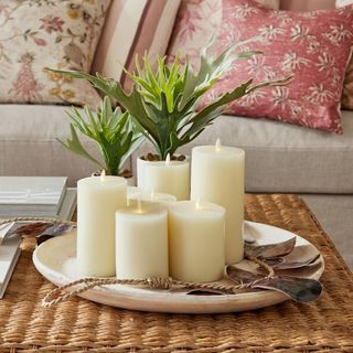 Premium Flickering Flameless Wax Candles on a rattan placemat.