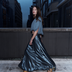 model wearing a striking blue silk skirt