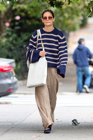 katie holmes wears a striped sweater and khaki pants