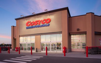 The exterior of a Costco warehouse club at dusk