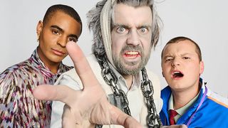 A still from Bad Education: A Christmas Carol showing Stephen (Layton Williams) and Mitchell (Charlie Wernham) standing behind Alfie Wickers (Jack Whitehall). Alfie is wearing grey make-up with his hair and stubble tinted white, and he has large metal chains hanging around his neck