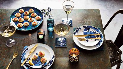 dining table with blue floral plates and glasses