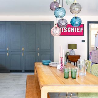 kitchen diner with wooden dining table and blue cabinets