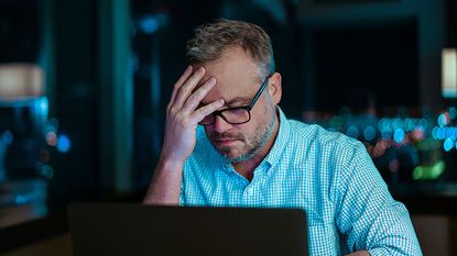 Worried man on a laptop