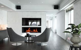 Lounge area with a fireplace in the site at Barcelona’s Hotel Arts