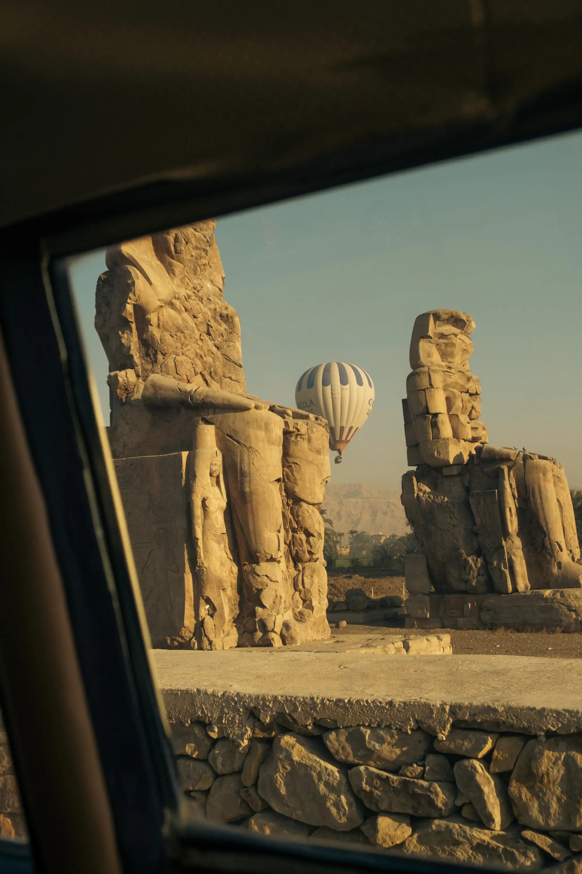 An image of a hot air balloon rising above the landscape in Luxor