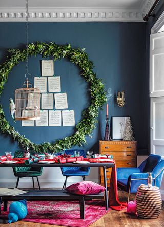 Blue living room decorated for Christmas with oversized wreath