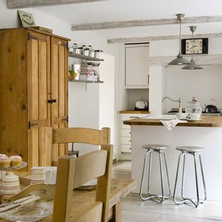 kitchen room with white walls and wooden cupboard