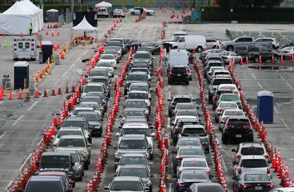 Cars wait in line at a coronavirus testing site