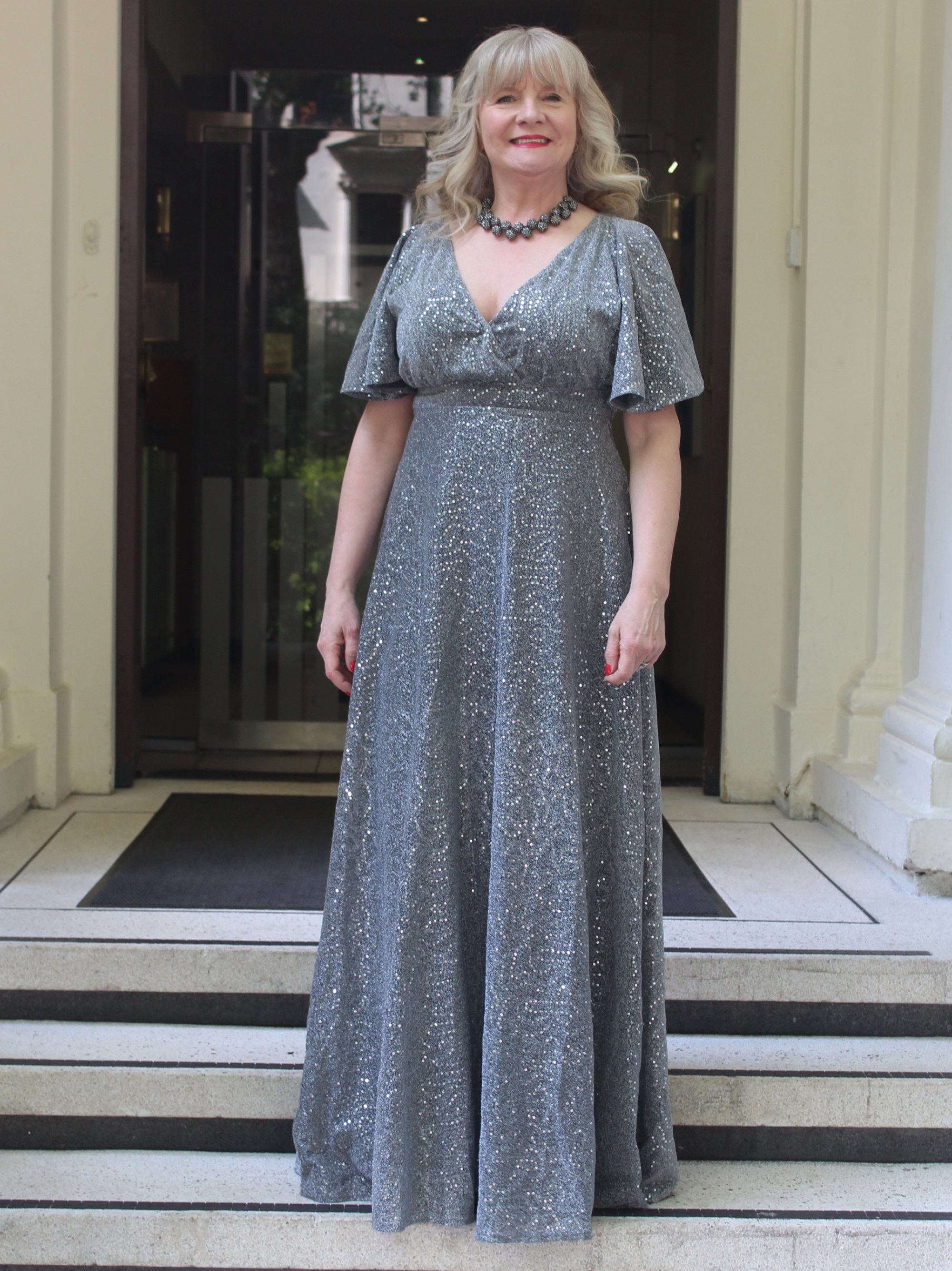 Julie Player wearing Goddiva, Goddiva Sequin Lurex Flutter Sleeve Maxi Dress - Silver
