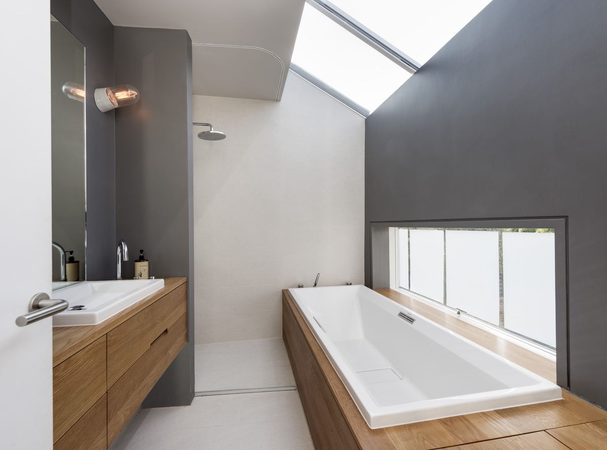 blue and white bathroom with rooflights above