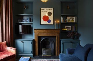 Living room with blue walls and cabinets and fireplace