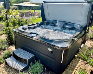 hydrolife hot tub surrounded by planting
