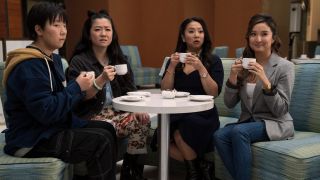 Sabrina Wu, Sherry Cola, Stephanie Hsu and Ashley Park all holing mugs in Joy Ride.