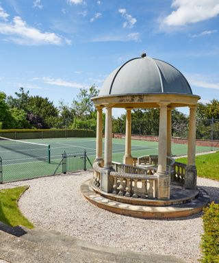 Robbie Williams' tennis court in country garden