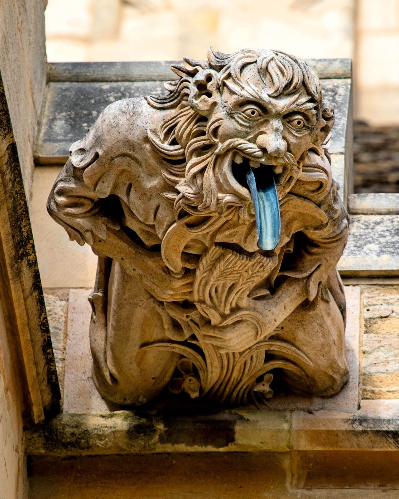 An ornate and beautifully sculpted Gargoyle on the exterior of Gloucester Cathedral.