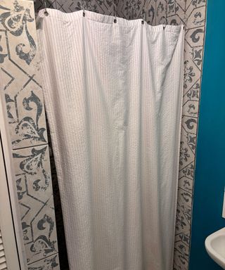 shower enclosure with white shower curtain