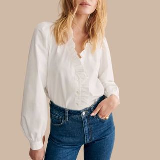 Image of woman wearing white blouse with denim blue jeans 