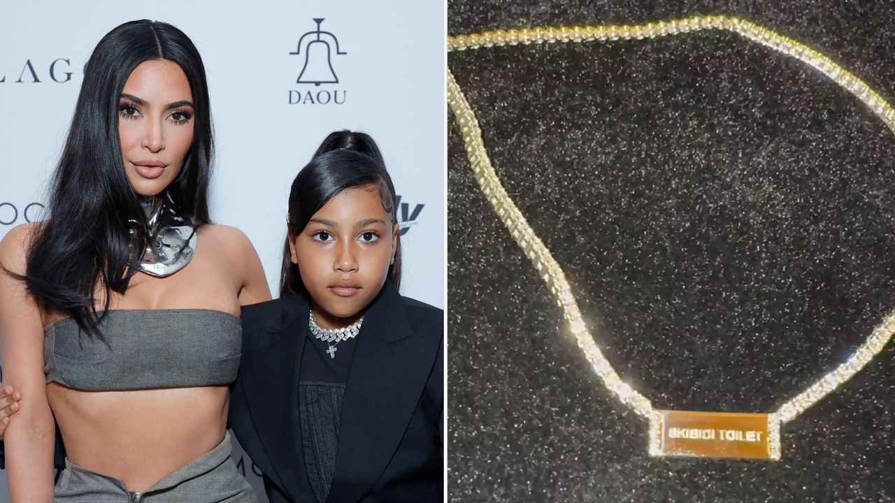 Kim Kardashian wears a bandeau top and shows her bare midriff while posing with daughter North West who is wearing a black suit jacket and choker