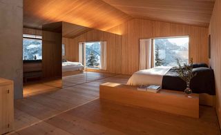 Bedroom with wooden floor and walls, window