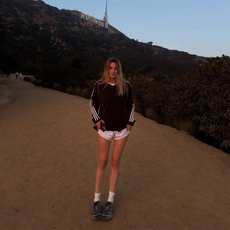 Camille Charriere hiking in front of the Hollywood sign.