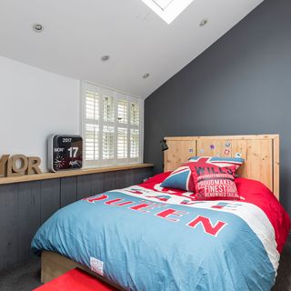 attic bedroom with grey wall and carpet flooring