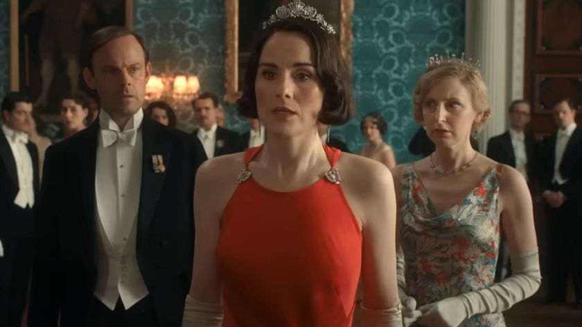Harry Hadden-Paton and Laura Carmichael watch on in shock as Michelle Dockery stands with upset in Downton Abbey: The Grand Finale.