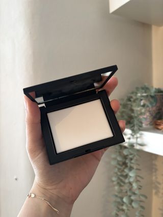 Mica Ricketts holding NARS Light Reflecting Pressed Setting Powder