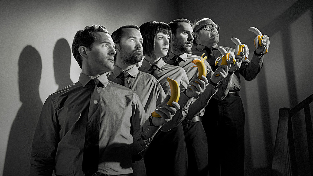 A promotional image showing the main cast of It's Always Sunny in Philadelphia holding bananas