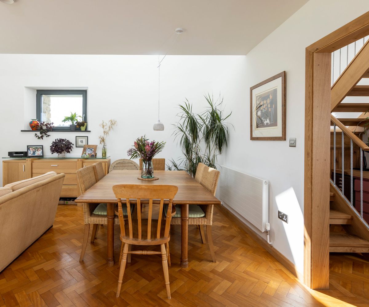 An open plan dining room with parquet flooring