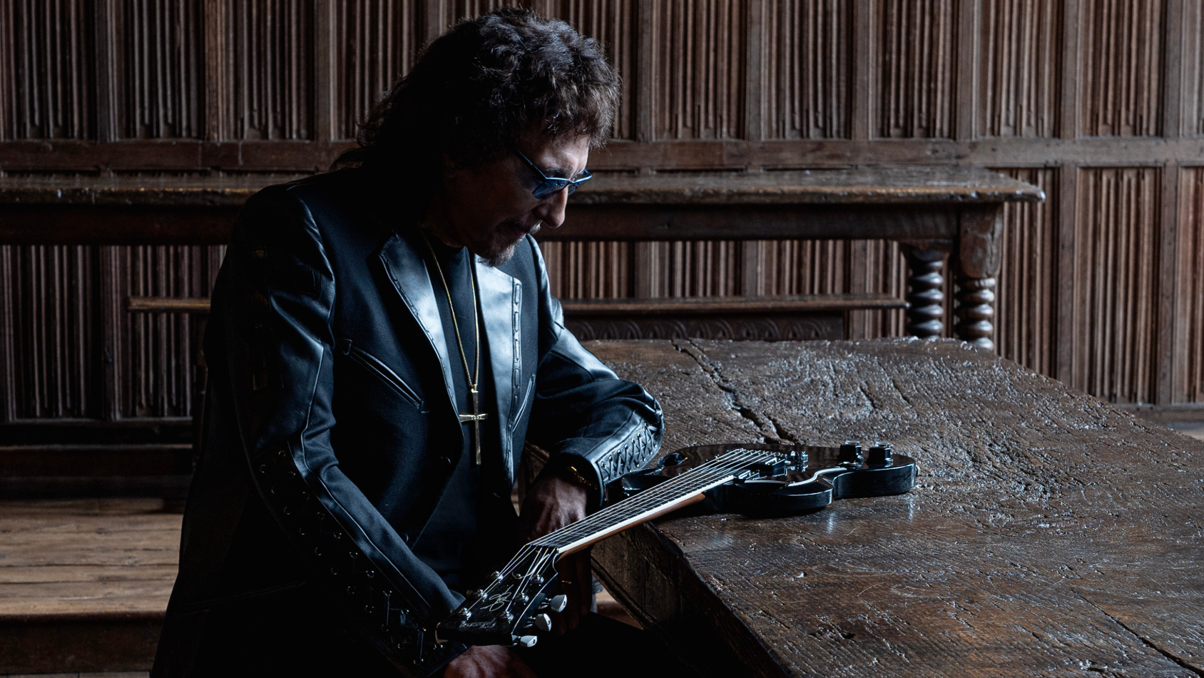 Tony Iommi sitting at a table