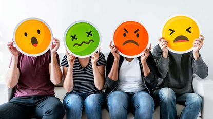 Four people holding up frustrated emoji faces